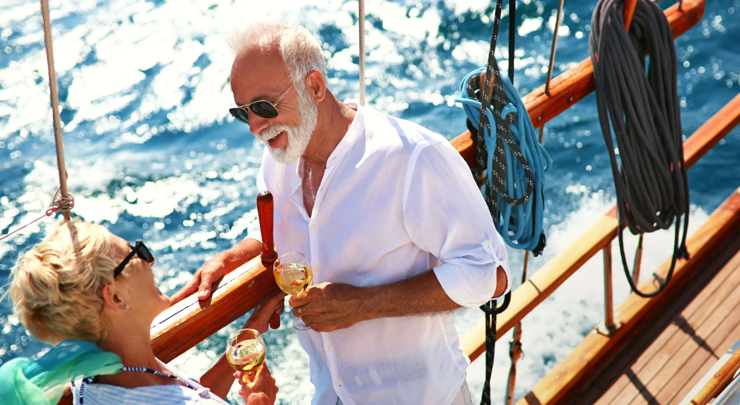Older couple smiling and relaxing on a cruise